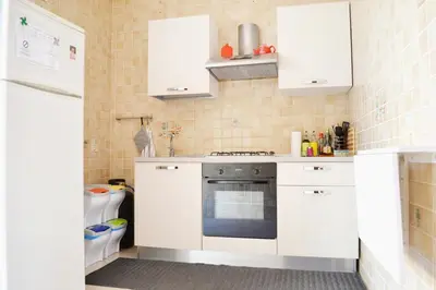 a kitchen with white cabinets and a stove at Appartamento da Andrea in Alcamo