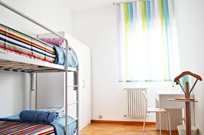 a bedroom with a bunk bed and a desk at Appartamento da Andrea in Alcamo