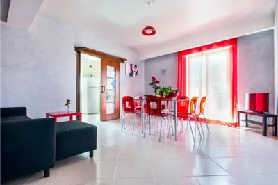 a living room with a couch and a table and chairs at Appartamento da Andrea in Alcamo