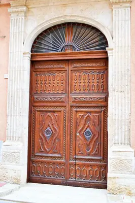 a large wooden door on the side of a building at Appartamento da Andrea in Alcamo