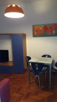 a room with a table and chairs and a blue door at Villa Giannì in Palermo
