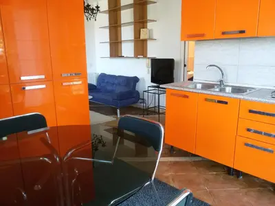 a kitchen with orange cabinets and a sink at Villa Giannì in Palermo