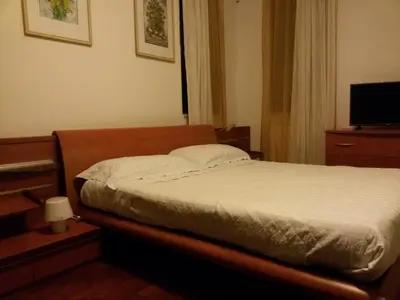 a bedroom with a bed and a television in it at Villa Giannì in Palermo
