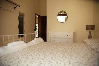 a bed in a bedroom with two nightstands and two lamps at BnB DonnaLaura in Carini