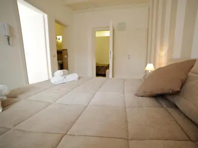 a large bed in a room with a large window at Le Quattro Perle in Terrasini