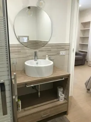a bathroom sink with a large mirror above it at Le Quattro Perle in Terrasini