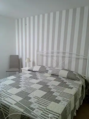 a bedroom with a bed with a quilt on it at Casa Vacanze TAMARA in Balestrate