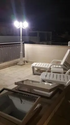 a group of chairs sitting on a roof at night at Casa Vacanze TAMARA in Balestrate