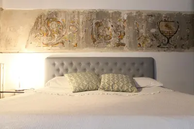 a white bed with two pillows on top of it at Speciale Apartment in Palermo