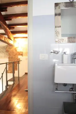 a bathroom with a sink and a staircase at Speciale Apartment in Palermo