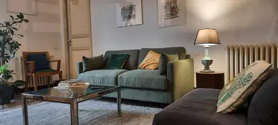 a living room with a couch and a table at Speciale Apartment in Palermo