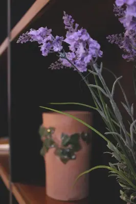 a vase filled with purple flowers on a table at Speciale Apartment in Palermo