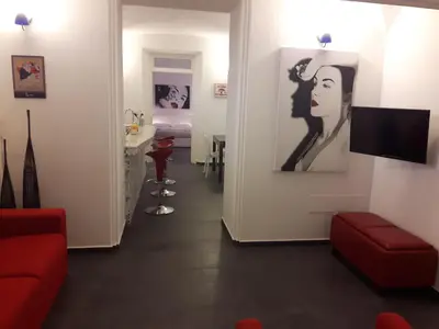 a hallway with a red couch and a living room at A un passo dal Massimo in Palermo