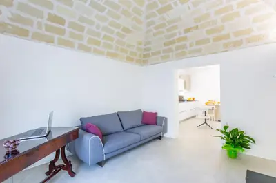 a living room with a couch and a table at Catalina in San Vito lo Capo