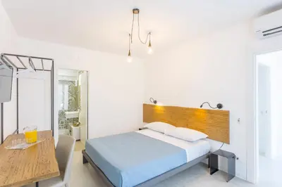 a bedroom with a bed and a wooden headboard at Catalina in San Vito lo Capo