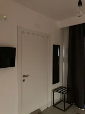 a white door in a room with a black curtain at Catalina in San Vito lo Capo