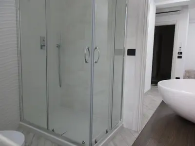 a glass shower in a bathroom with a sink at Le Dimore di Enea in Castellammare del Golfo