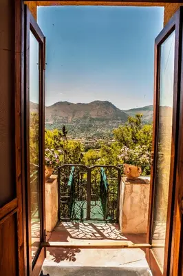 an open door to a balcony with a view at Palazzo Q-tò in Monreale