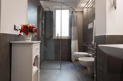 a bathroom with a shower and a toilet and a sink at My Way - Suite - Rooms - Palazzo San Matteo in Palermo