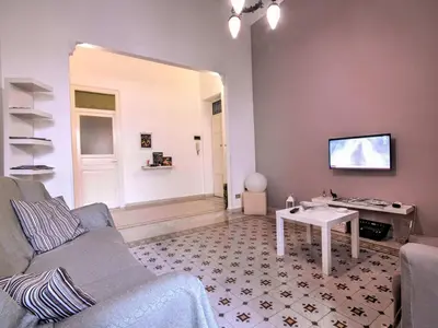 a living room with a couch and a table at Liberty Apartment in Palermo