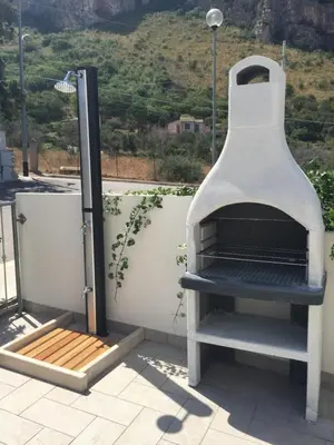 a pizza oven sitting on top of a roof at Un mare di Blu - Casa Cobalto in Macari