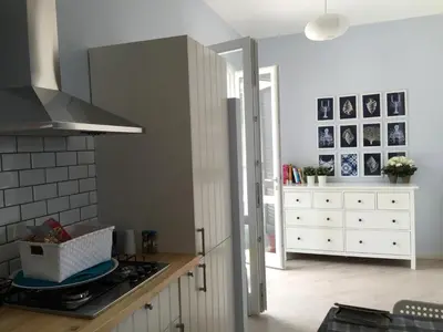 a kitchen with a stove top oven next to a counter at Un mare di Blu - Casa Cobalto in Macari