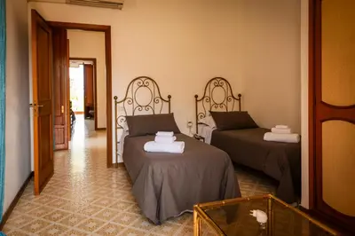 a room with two beds and a mirror at Casa del carrubo in Carini