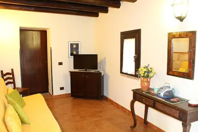 a living room with a couch and a television at Casale Maddalena in Carini