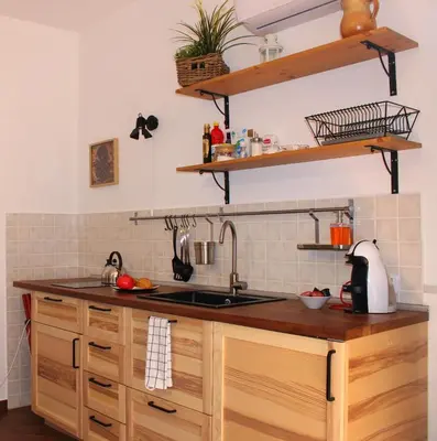 a kitchen with a sink and wooden cabinets at Pirtuso Del Porto in Palermo