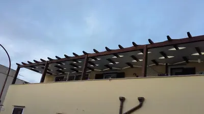 a building with a fence with two pairs of swords at Residenza del Mare & SPA in San Vito lo Capo