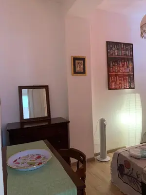 a living room with a table with a mirror and a table sidx sidx sidx at House in Mondello in Mondello
