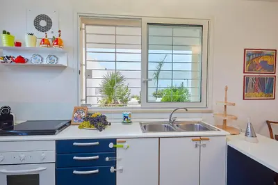 a kitchen with a sink and a window at Villa Bonifato vista sulle campagne e sul mare siciliano COZY HOUSE ITALY in Alcamo