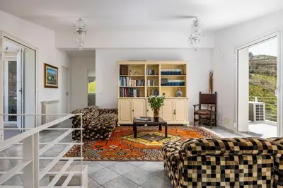 a living room with couches and a table at Villa Bonifato vista sulle campagne e sul mare siciliano COZY HOUSE ITALY in Alcamo