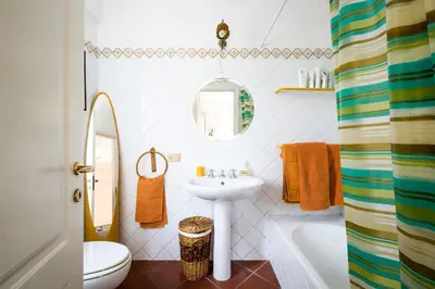 a white bathroom with a sink and a mirror at Panoramica Blu in Palermo