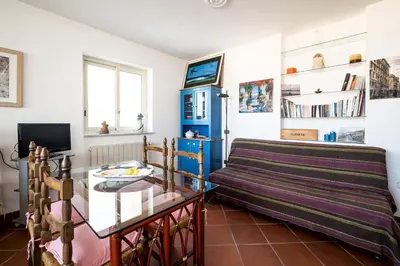 a living room with a couch and a glass table at Panoramica Blu in Palermo