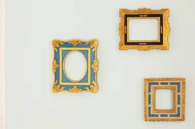 three framed mirrors hanging on a white wall at Marina di Petrolo Hotel & SPA in Castellammare del Golfo