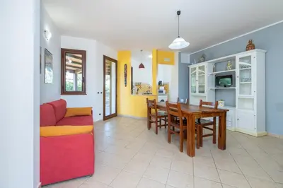 a living room with a red couch and a table at Arvilla's Houses in Campofelice di Roccella