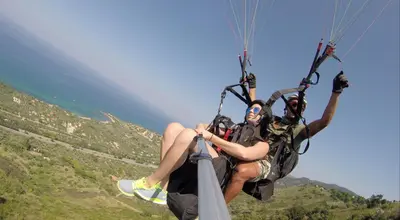two people are riding on a parachute at Arvilla's Houses in Campofelice di Roccella