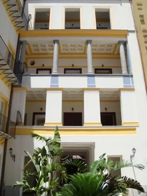 a white building with blue and yellow trim at Appartamento Alloro 2 in Palermo