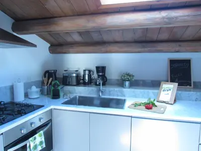 a kitchen with a sink and a stove at Appartamento Alloro 2 in Palermo