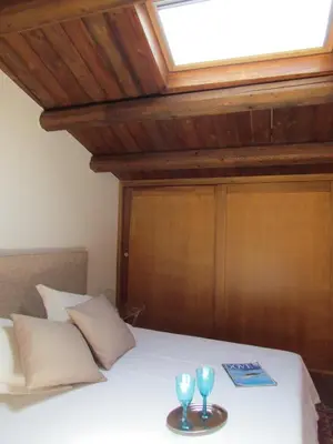 a bedroom with a bed with two glasses on it at Appartamento Alloro 2 in Palermo