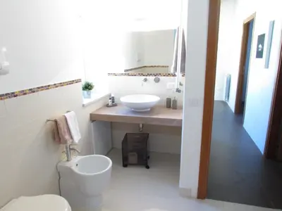 a bathroom with a white toilet and a sink at Appartamento Alloro 2 in Palermo