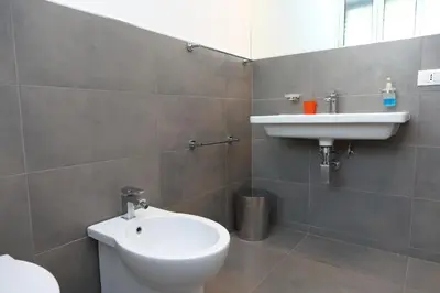 a bathroom with a white toilet and a sink at casa verdemare in Cefalù