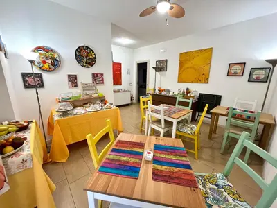 a living room with a table and a dining room at LeAlbe di Sicilia in Palermo