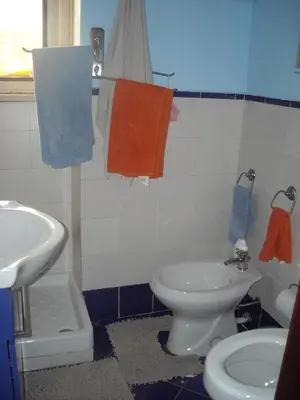 a bathroom with a white toilet and a sink at Apartment Ro a Mondello in Mondello