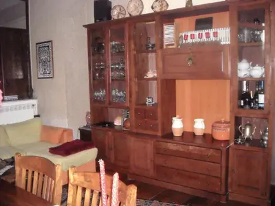 a large wooden cabinet in a room with a table at Apartment Ro a Mondello in Mondello
