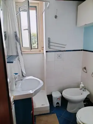 a white bathroom with a sink and a toilet at Apartment Ro a Mondello in Mondello