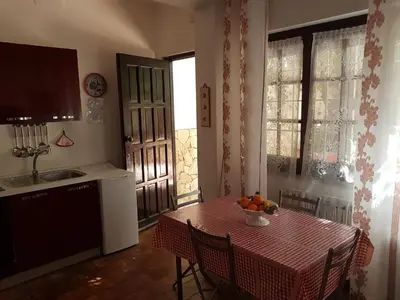 a kitchen with a table with a bowl of fruit on it at Villa Ania in Mondello