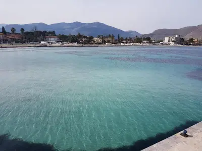 a large body of water with mountains in the background at Villa Ania in Mondello