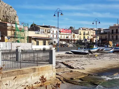 a group of boats sitting on the beach at Villa Ania in Mondello